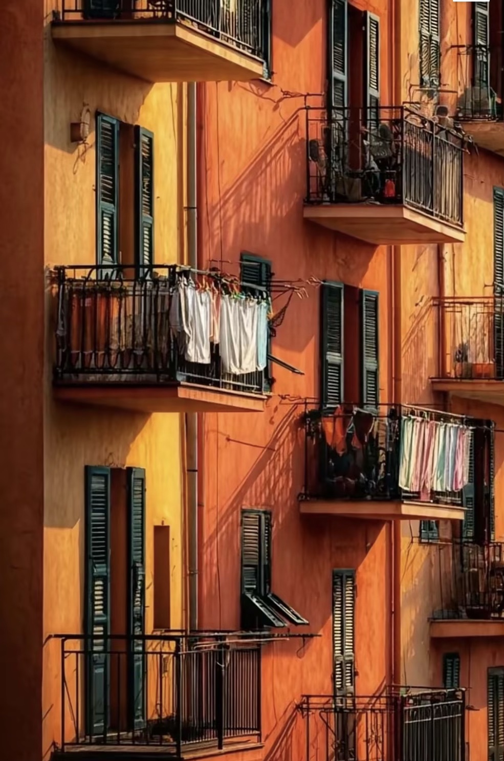 Terracotta balconies in hard afternoon light