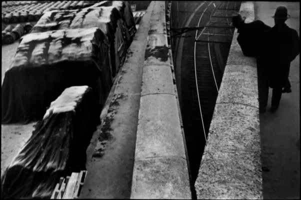 A Graphic Stage of Rails, Stone, and a Passing Figure